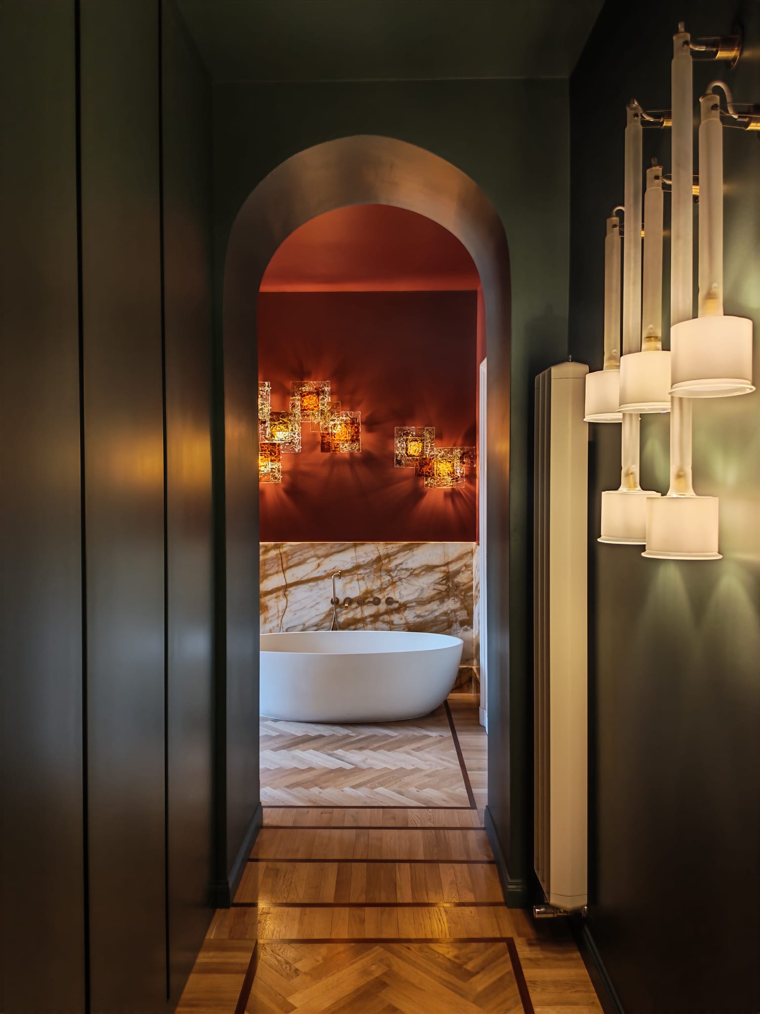 Green arch above a marble bathroom